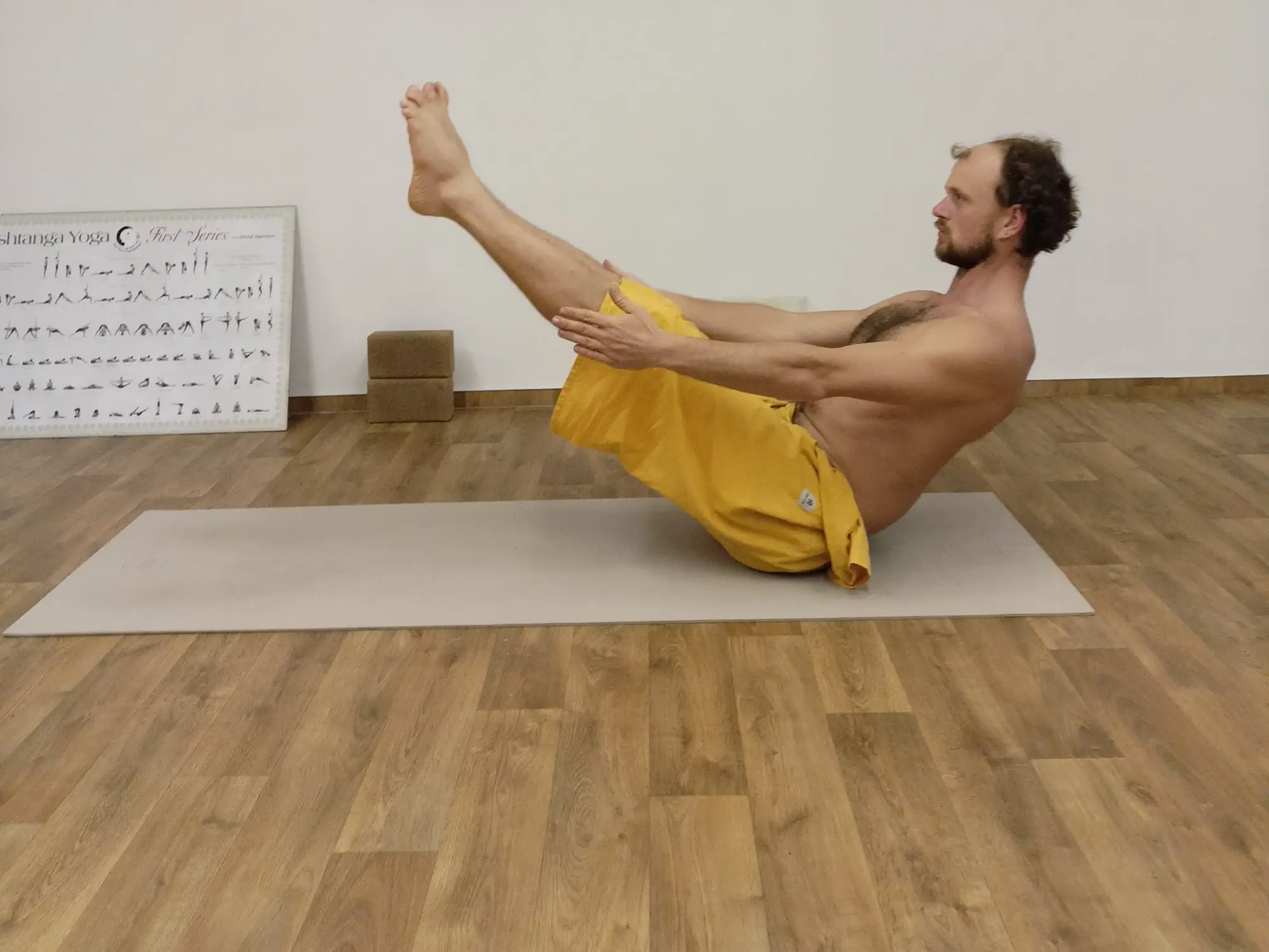 Petr Kolář in boat pose (navasana) at the Yogastation studio