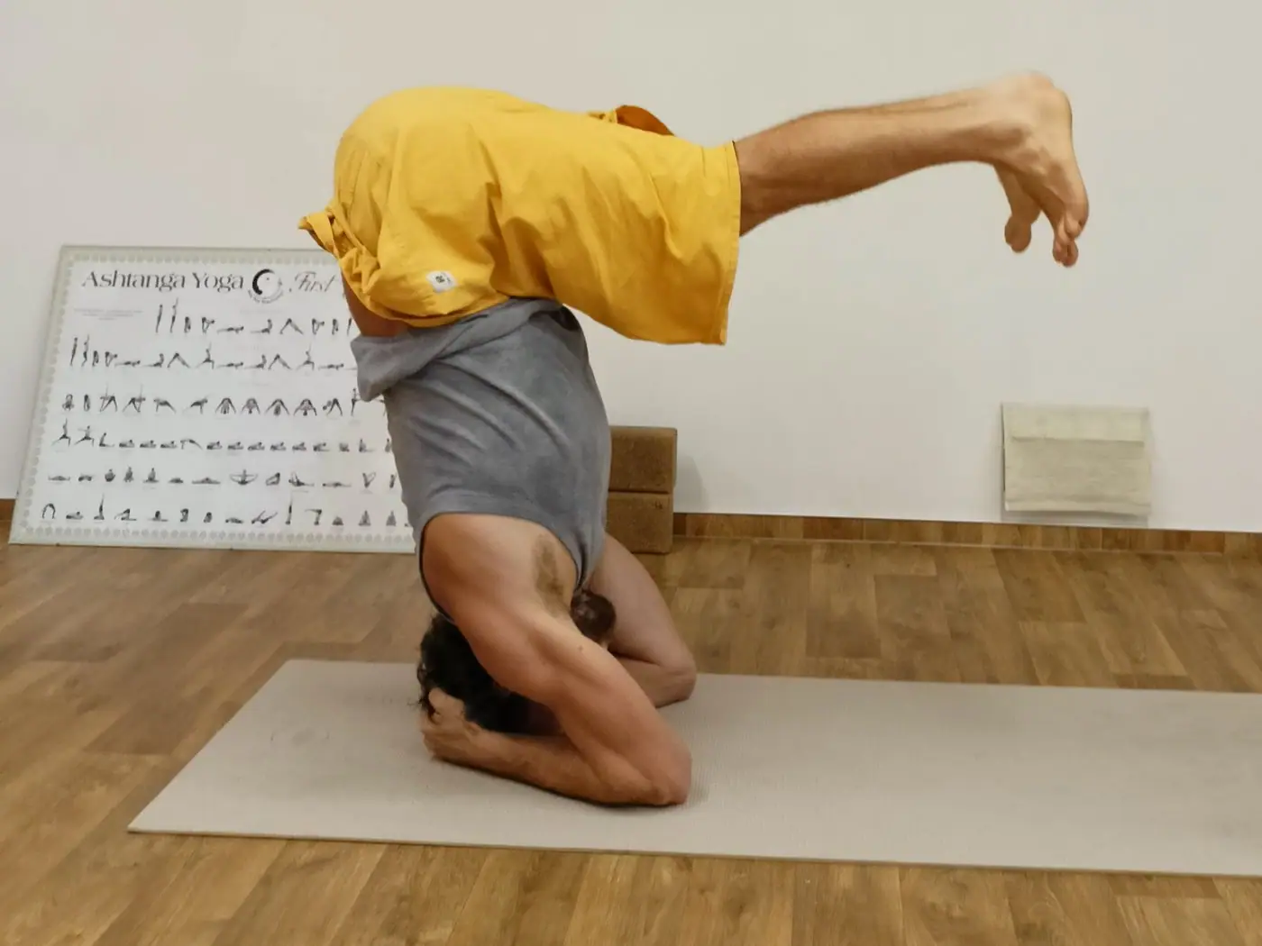 Preparation for headstand (sirsasana) at the Yogastation Tábor studio